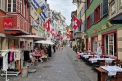 Zürich old town street with Swiss flags
