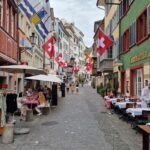 Our Most Beautiful 3 Days in Zurich, Switzerland Zürich street with Swiss flags