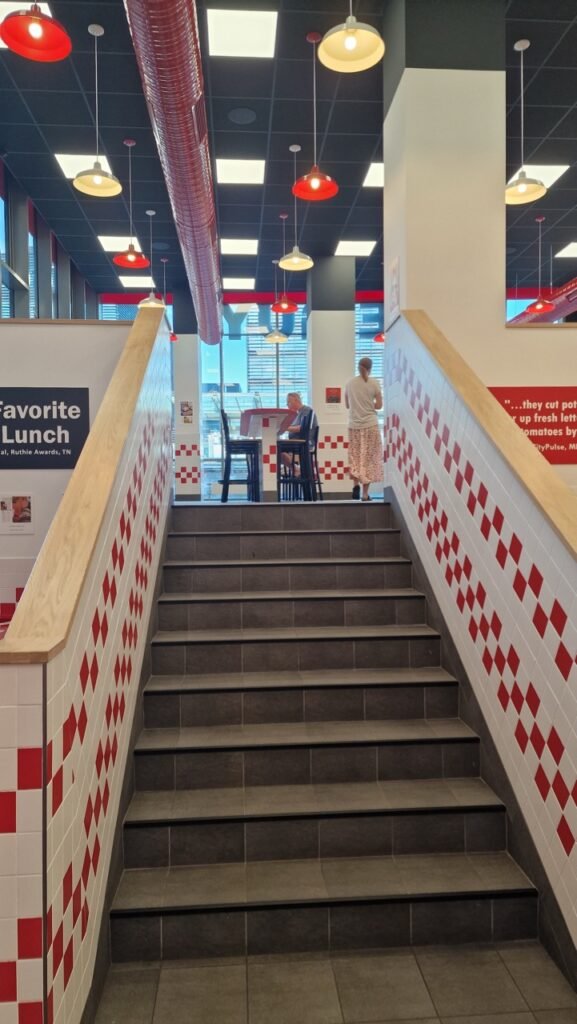 Five Guys Copenhagen Fields interior stairs
